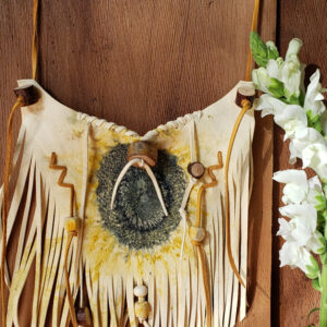 The necklace is adorned with birch branch beads, hand-dyed beads, and a vintage bone bead for decorative flair.